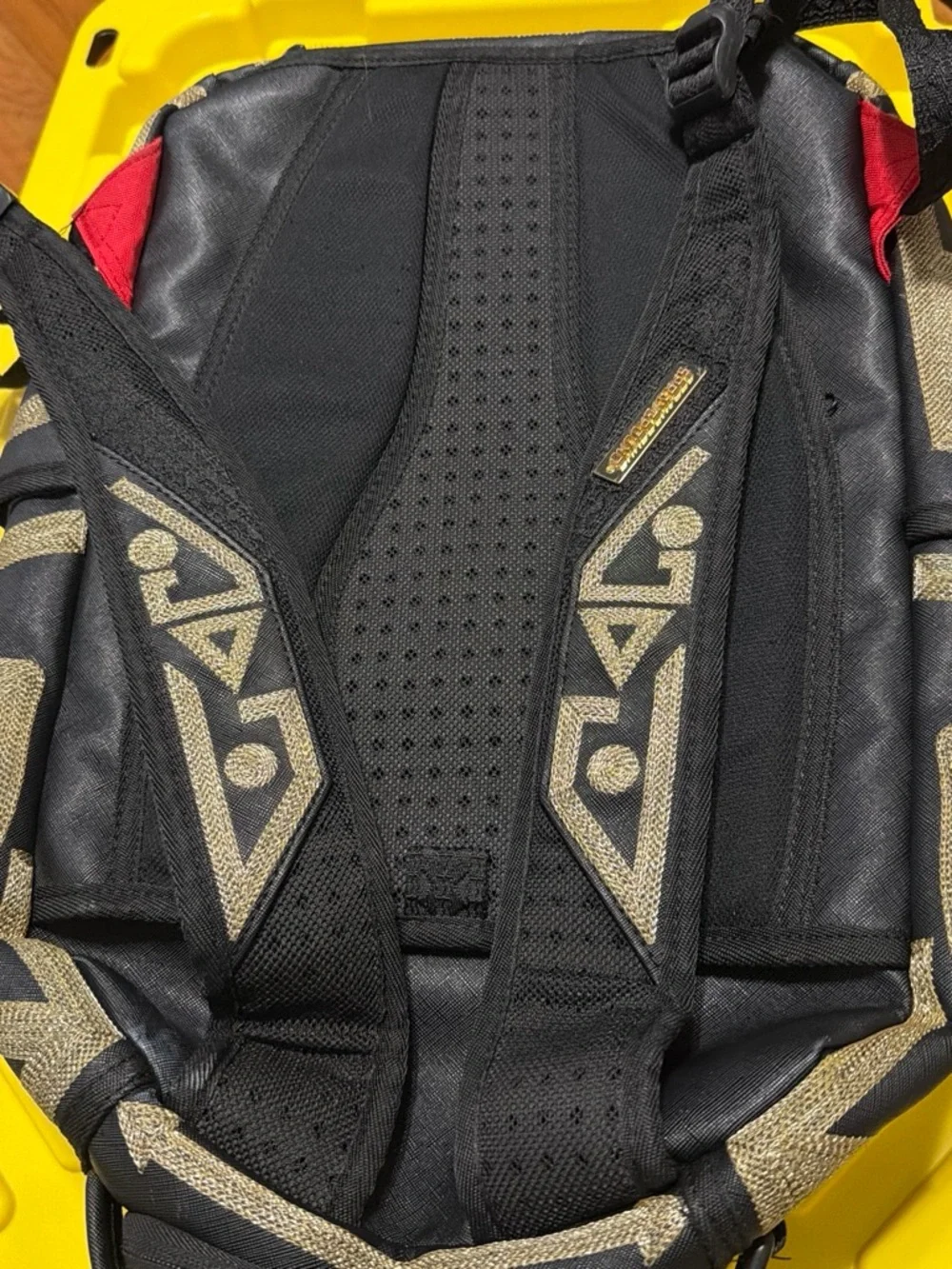 Sprayground Black Backpack with Metallic Gold Tribal Pattern